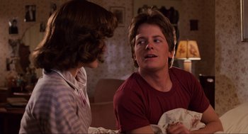 Movie still from “Back to the Future” (1985), directed by Robert Zemeckis – Two people sitting on a couch talking to each other; Close Up shot, Over the shoulder angle