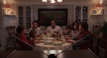 Movie still from “Back to the Future” (1985), directed by Robert Zemeckis – A group of people sitting around a dinner table; Wide shot, High angle