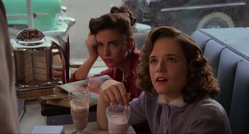 Movie still from “Back to the Future” (1985), directed by Robert Zemeckis – Two women sitting at a table in front of drinks; Close Up shot, Over the shoulder angle