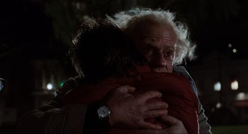 Movie still from “Back to the Future” (1985), directed by Robert Zemeckis – A man hugging another man in the dark; Close Up shot, Over the shoulder angle