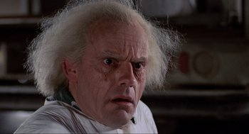 Movie still from “Back to the Future” (1985), directed by Robert Zemeckis – A man that has a white wig on his head; Close Up shot, Low angle