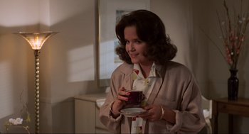 Movie still from “Back to the Future” (1985), directed by Robert Zemeckis – A woman holding a coffee cup in her hands; Medium shot, Over the shoulder angle