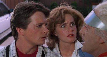 Movie still from “Back to the Future Part II” (1989), directed by Robert Zemeckis – A young woman and a young man looking at each other; Close Up shot, Over the shoulder angle