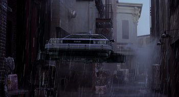 Movie still from “Back to the Future Part II” (1989), directed by Robert Zemeckis – A car that is flying through the air in the rain; Extreme Wide shot, Low angle