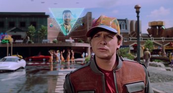 Movie still from “Back to the Future Part II” (1989), directed by Robert Zemeckis – A man wearing a red jacket and a red hat; Medium shot, Over the shoulder angle