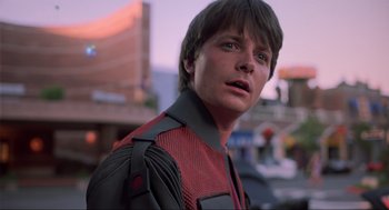 Movie still from “Back to the Future Part II” (1989), directed by Robert Zemeckis – A young man wearing a red and black jacket; Close Up shot, Over the shoulder angle