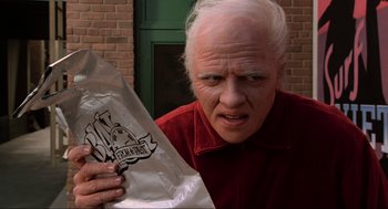 Movie still from “Back to the Future Part II” (1989), directed by Robert Zemeckis – An older man holding a bag of food; Close Up shot, High angle