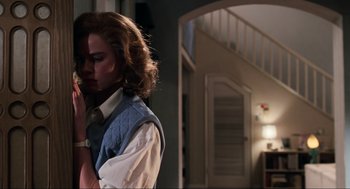 Movie still from “Back to the Future Part II” (1989), directed by Robert Zemeckis – A woman standing in front of a staircase in a room; Medium shot, Low angle