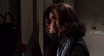 Movie still from “Back to the Future Part II” (1989), directed by Robert Zemeckis – A young woman looking out a window at night; Close Up shot, Over the shoulder angle