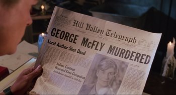 Movie still from “Back to the Future Part II” (1989), directed by Robert Zemeckis – A person holding up a newspaper with a picture of george mcflys murder on it; Extreme Close Up shot, Overhead angle