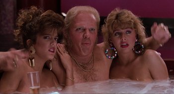 Movie still from “Back to the Future Part II” (1989), directed by Robert Zemeckis – A man and two women are posing for a picture; Close Up shot, Low angle