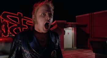 Movie still from “Back to the Future Part II” (1989), directed by Robert Zemeckis – A man with a red hair and a blue shirt is screaming; Close Up shot, Low angle