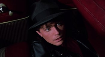 Movie still from “Back to the Future Part II” (1989), directed by Robert Zemeckis – A young man wearing a black hat and a leather jacket; Close Up shot, Overhead angle