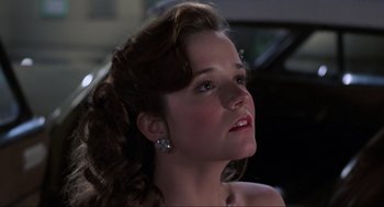 Movie still from “Back to the Future Part II” (1989), directed by Robert Zemeckis – A beautiful young lady with a large ear piercing; Close Up shot, Low angle