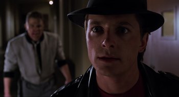 Movie still from “Back to the Future Part II” (1989), directed by Robert Zemeckis – A person wearing a hat; Close Up shot, Over the shoulder angle