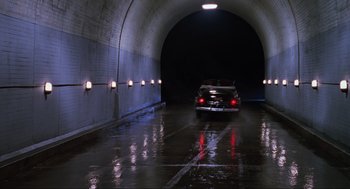 Movie still from “Back to the Future Part II” (1989), directed by Robert Zemeckis – A car is driving through a tunnel at night; Extreme Wide shot, Low angle