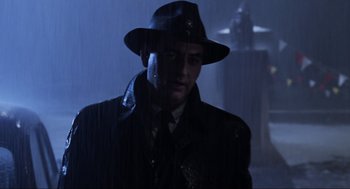 Movie still from “Back to the Future Part II” (1989), directed by Robert Zemeckis – A man wearing a hat and a coat; Medium shot, Low angle