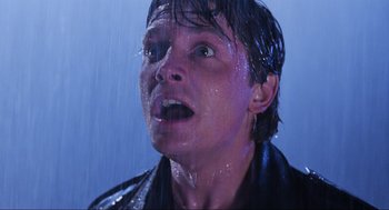 Movie still from “Back to the Future Part II” (1989), directed by Robert Zemeckis – A man in a leather jacket is wet and looking surprised; Close Up shot, Low angle