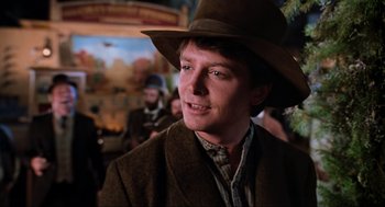 Movie still from “Back to the Future Part II” (1989), directed by Robert Zemeckis – A man wearing a brown hat and a brown jacket; Close Up shot, Over the shoulder angle