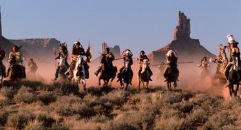 Movie still from “Back to the Future Part III” (1990), directed by Robert Zemeckis – A group of people riding on the backs of horses; Extreme Wide shot, Low angle