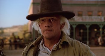 Movie still from “Back to the Future Part III” (1990), directed by Robert Zemeckis – An older man wearing a brown hat and a jacket; Close Up shot, Low angle