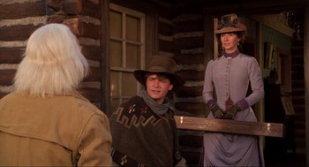 Movie still from “Back to the Future Part III” (1990), directed by Robert Zemeckis – A group of people standing in front of a log cabin; Medium shot, Over the shoulder angle