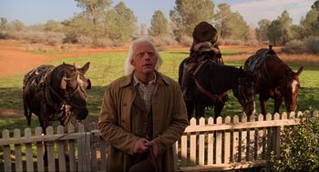 Movie still from “Back to the Future Part III” (1990), directed by Robert Zemeckis – A man standing in front of a group of horses; Medium shot, Over the shoulder angle