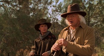 Movie still from “Back to the Future Part III” (1990), directed by Robert Zemeckis – A man and a man in a cowboy hat; Close Up shot, Over the shoulder angle