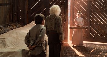 Movie still from “Back to the Future Part III” (1990), directed by Robert Zemeckis – Two men and a woman standing in front of a barn; Wide shot, Over the shoulder angle