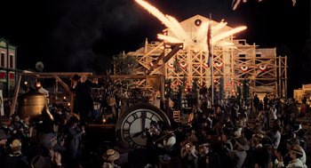 Movie still from “Back to the Future Part III” (1990), directed by Robert Zemeckis – A crowd of people sitting in front of an amusement ride; Extreme Wide shot, High angle