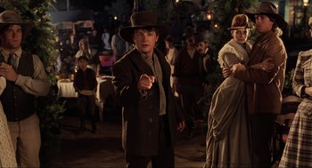 Movie still from “Back to the Future Part III” (1990), directed by Robert Zemeckis – A man in a brown suit and a brown hat; Medium shot, Over the shoulder angle