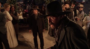 Movie still from “Back to the Future Part III” (1990), directed by Robert Zemeckis – A man with a beard wearing a cowboy hat; Medium shot, Over the shoulder angle