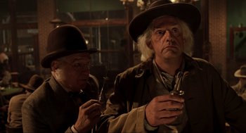 Movie still from “Back to the Future Part III” (1990), directed by Robert Zemeckis – A man in a hat and a man in a hat and a man in a hat and a man in a hat and a man in a hat; Medium shot, Over the shoulder angle