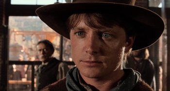 Movie still from “Back to the Future Part III” (1990), directed by Robert Zemeckis – A person wearing a hat; Close Up shot, Over the shoulder angle