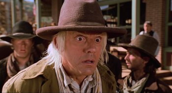 Movie still from “Back to the Future Part III” (1990), directed by Robert Zemeckis – A man with a hat and a surprised look on his face; Close Up shot, Low angle