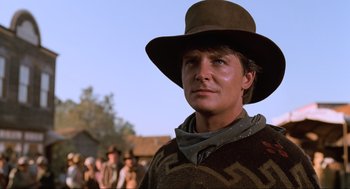 Movie still from “Back to the Future Part III” (1990), directed by Robert Zemeckis – A man wearing a cowboy hat in a movie scene; Close Up shot, Low angle