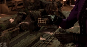 Movie still from “Back to the Future Part III” (1990), directed by Robert Zemeckis – A hand is holding a bunch of ammunition; Medium shot, Over the shoulder angle