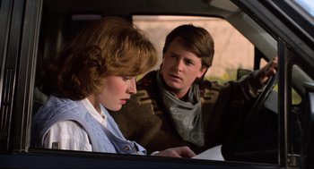 Movie still from “Back to the Future Part III” (1990), directed by Robert Zemeckis – A man and a woman looking at a piece of paper in the back of a car; Medium shot, Over the shoulder angle