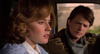 Movie still from “Back to the Future Part III” (1990), directed by Robert Zemeckis – A woman sitting next to another woman in a car; Close Up shot, Over the shoulder angle