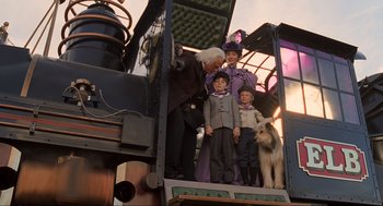 Movie still from “Back to the Future Part III” (1990), directed by Robert Zemeckis – A group of people standing on top of a train car; Wide shot, Low angle