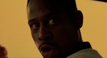 Movie still from “Bad Boys” (1995), directed by Michael Bay – A man's face in a dark room; Close Up shot, Low angle