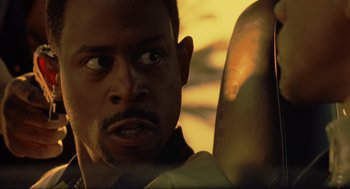 Movie still from “Bad Boys” (1995), directed by Michael Bay – A man's face as he sits in a car; Close Up shot, Over the shoulder angle
