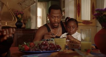 Movie still from “Bad Boys” (1995), directed by Michael Bay – A man and a little girl sitting at a dinner table; Medium shot, Over the shoulder angle