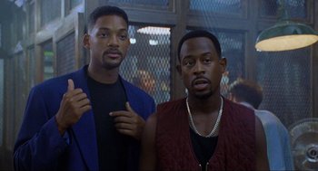 Movie still from “Bad Boys” (1995), directed by Michael Bay – A couple of men standing next to each other; Close Up shot, Low angle