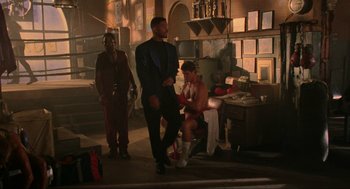 Movie still from “Bad Boys” (1995), directed by Michael Bay – A group of men standing next to each other in a room; Wide shot, Low angle