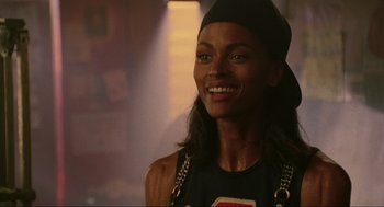 Movie still from “Bad Boys” (1995), directed by Michael Bay – A woman smiling and wearing a black hat; Close Up shot, Low angle