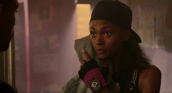 Movie still from “Bad Boys” (1995), directed by Michael Bay – A person with a glove in a room; Close Up shot, Low angle