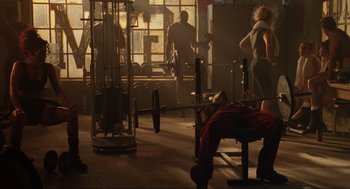 Movie still from “Bad Boys” (1995), directed by Michael Bay – A group of people working out in a gym; Wide shot, Low angle