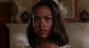 Movie still from “Bad Boys” (1995), directed by Michael Bay – An image of a woman with a serious look on her face; Close Up shot, Over the shoulder angle