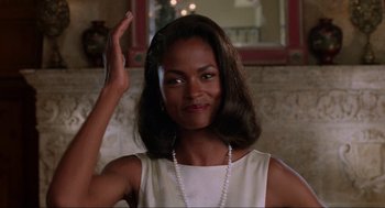Movie still from “Bad Boys” (1995), directed by Michael Bay – A woman in a white dress holding her hand up; Close Up shot, Over the shoulder angle